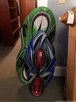 Ripstick Razor on blue and black Sno-Storm snowboard, green SkinLizard snowboard behind them