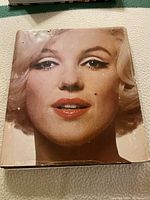 Front cover close-up image of Marilyn Monroe's face on the book titled 'Marilyn a Biography by Norman Mailer'