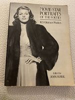 Front cover of the softcover book showing a black and white photo of a woman in a fur coat.