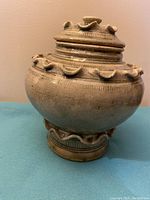 Full view of the pottery jar showing the body and lid details