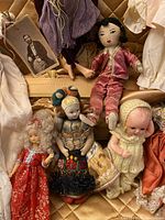 Close-up of assorted vintage dolls showing details of clothing and faces.