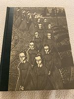 Photo of the front cover of the vintage Jane Eyre book showing engraved illustration of procession of figures.