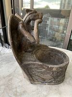 Side view showing the full gargoyle flower pot with decorative detailing and plant holder opening.