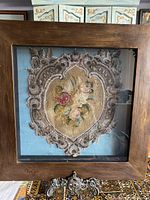 Front view of vintage shadowbox with floral hand-beaded embroidery under glass.