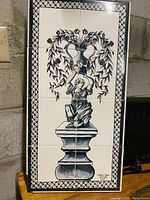 Full view of the ceramic tile wall hanging showing the entire artwork and border design.