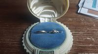 Two rings displayed in vintage ring box on blue velvet insert