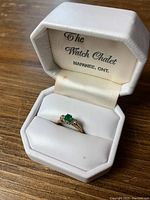 Ring displayed in original white presentation box stamped 'The Watch Chalet Napanee, Ont.'