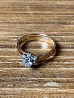 Overhead view of ring showing central diamond and surrounding stones