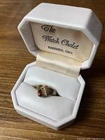 Gold ladies ring displayed in a white jewelry box labeled 'The Watch Chalet, Napanee, Ont.'