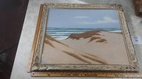 Overall view of framed pastel seascape on table