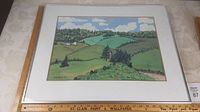 Framed watercolour painting showing rolling hills landscape with house and trees.