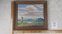 Full view of original oil painting in ornate gold frame showing landscape with clouds, trees, and water.