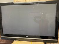 Front view of LG TV showing black screen and bezel.