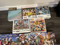 Various used jigsaw puzzles showing box art with animals, nature scenes, and book covers.