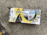 Bissell SpotLifter spot cleaner in original box, showing branding and partial product view through packaging window.
