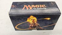 Front side of Magic The Gathering collector's box featuring character art with flame effects.