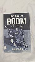 Front cover of the hardcover book 'Lowering the Boom: The Bobby Baun Story' by Bobby Baun.
