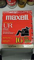 Sealed Maxell UR Normal Bias 16 pack cassette tapes with red packaging showing a person sitting and reading.