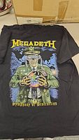 Front view of black Megadeth Symphony Of Destruction t-shirt showing detailed graphic of a skeletal military figure holding a globe with a fuse and chains.