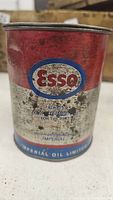 Front side of the vintage Esso oil can showing logo and aging on the label.