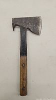 Full view of vintage hatchet showing metal head with wooden handle