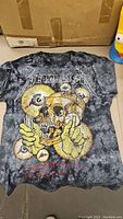 Full front view of vintage Metallica tie dye t-shirt with skull and eyeball graphic.