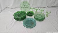Overview of entire glassware lot showing divided plates, round plates, and dessert glasses.