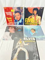 Full view of 5 vintage Elvis Presley vinyl records showing album covers including Girls! Girls! Girls!, Elvis in Hollywood, His Hand in Mine, and Madison Square Garden live album.
