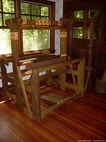Full view of the vintage hardwood loom showing the main structural frame with decorative painted floral designs and the pedal section.