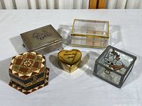 All five vintage lidded boxes shown together on white surface, clearly displaying size, shape, material and designs of each box.