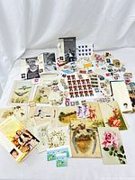 Full overview of the vintage and retro collection with postcards and stamp sheets spread out on white backdrop