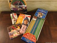 Lot contents showing round and long looms along with instructional books and booklet.