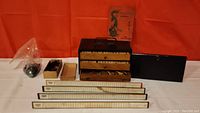 Overall lot of antique Pung Chow game items including wooden case, game pieces, score boards, and instruction booklet.