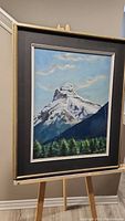 Full view of framed pastel artwork featuring Pilot Mountain on a wooden easel, showing the size and framing.