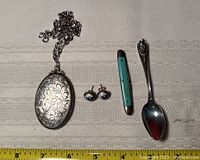 Full view of sterling silver engraved locket with chain, Delft earrings, turquoise miniature pocket knife, and sterling spoon