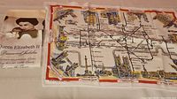 Photo showing Queen Elizabeth II Diamond Jubilee towel and a map towel with transportation route design.