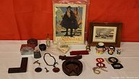 Full view of vintage collectibles laid out on white table against red background showing diverse items.