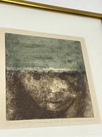 Close-up of the framed print showing the child's face and upper mat with partial title handwritten along bottom edge.