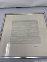 Framed artwork with minimalistic black lines on white background, signed Thomas 74 in lower right, title 'Line Series' on lower left.