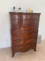 Photo of the full dresser showing overall structure, drawer configuration, and painted decoration on lower drawers.