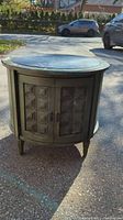 Front view of dark wooden vintage bar end table showing square panel doors and handles.