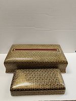 Two wooden boxes placed side by side against a white background, showing detailed pattern and shape of each box.