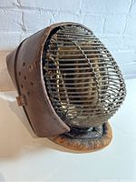 Angled front-right view showing leather exterior and metal grille mask