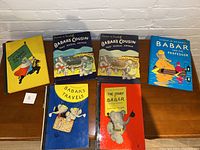 Top-down view of all five Babar books displaying colorful illustrated covers including two copies of 'That Rascal Arthur' and different other titles