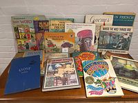 Photo showing a variety of children's books including Richard Scarry's Best Word Book Ever, The Far Side Gallery, Tintin, Why Mosquitoes Buzz in People's Ears, Gnomes, and Where the Wild Things Are.