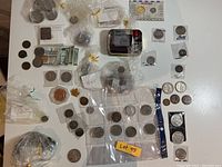 Overview photo of assorted coins, banknotes, and coins in bags and holders