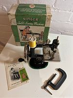 Singer No.20 child’s sewing machine with hand crank, original box, manual, needle pack, spool and clamp