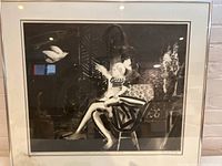 Frontal view of the framed black and white print showing seated mother and child with dove, signed and numbered.