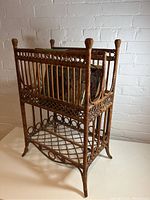 Full side view of the vintage wicker magazine rack showing the detailed weaving and structure.