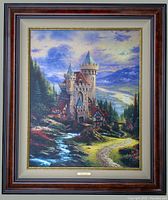 Framed Thomas Kinkade "Guardian Castle" canvas artwork showing the castle and landscape scene.